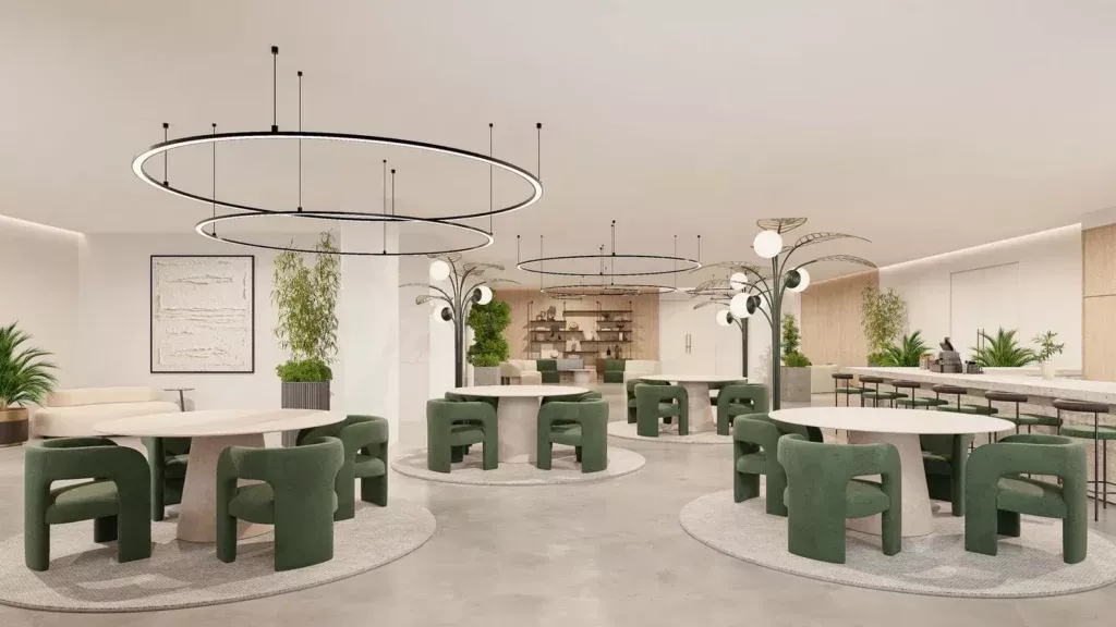 Open co-working lounge with green chairs and a circular pendant light
