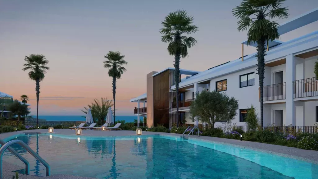 Swimming pool surrounded by palm trees and modern white buildings