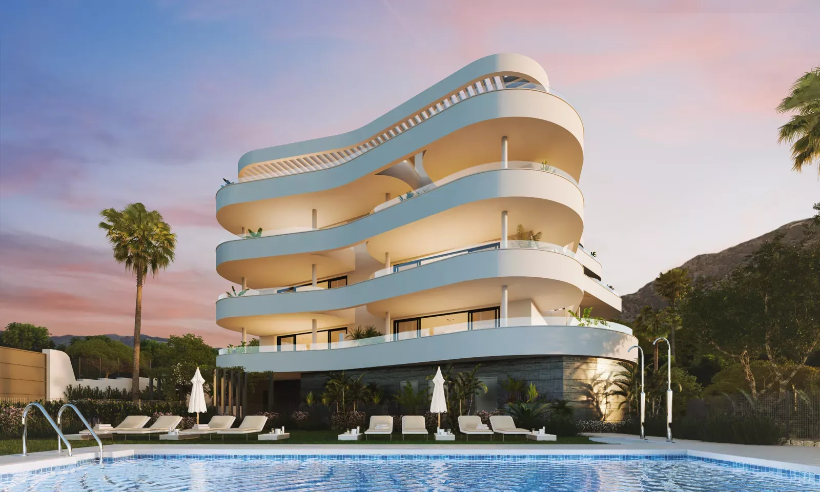 Curved white apartment building with terraces at sunset beside a pool in Higuerón West