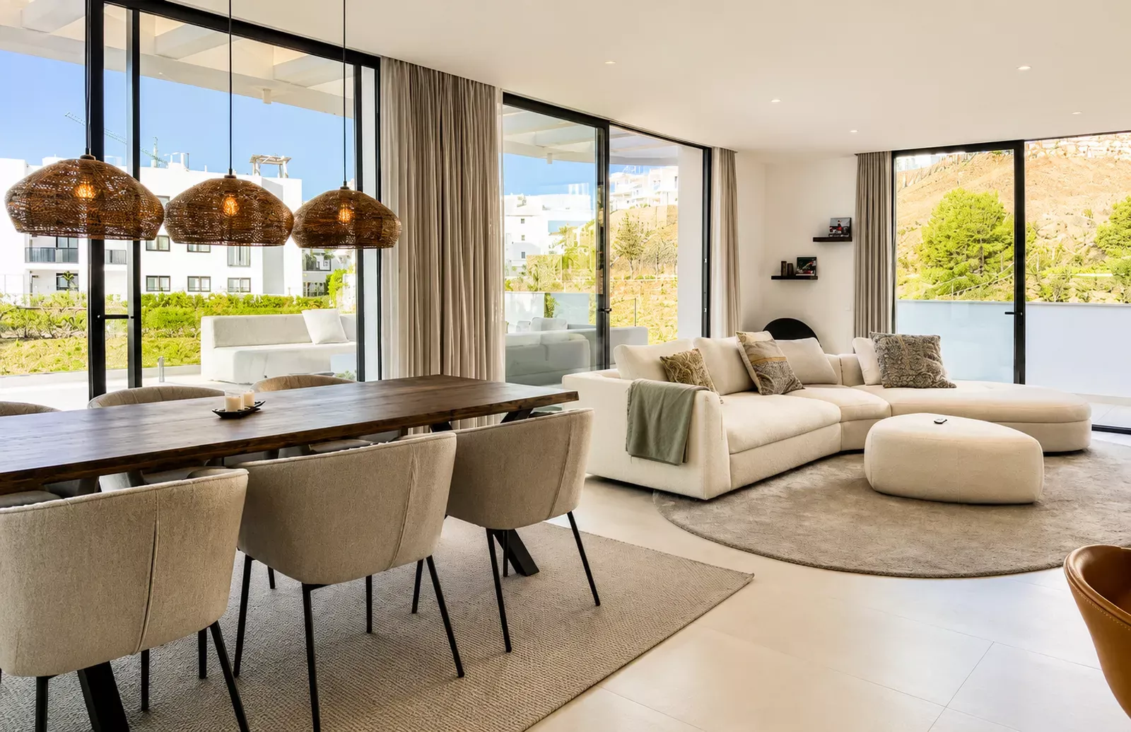 Living and dining room with modern pendant lights in the Higuerón West HW9 penthouse