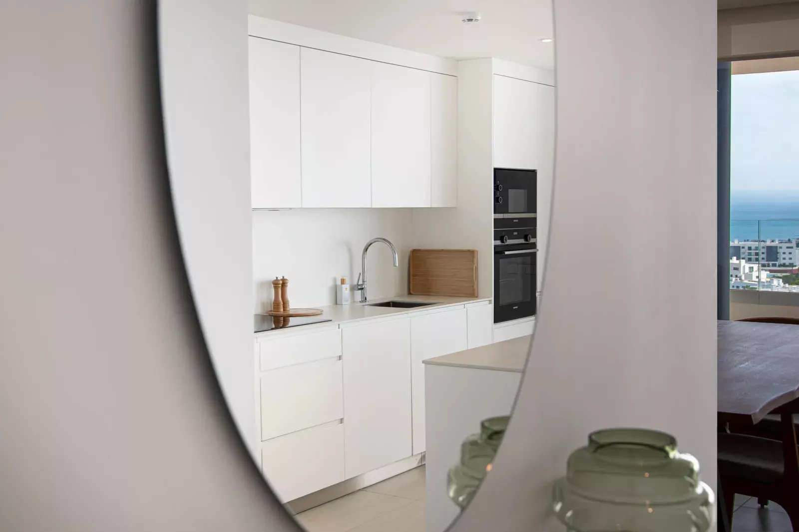 Kitchen detail with a round mirror in the HW3 apartment