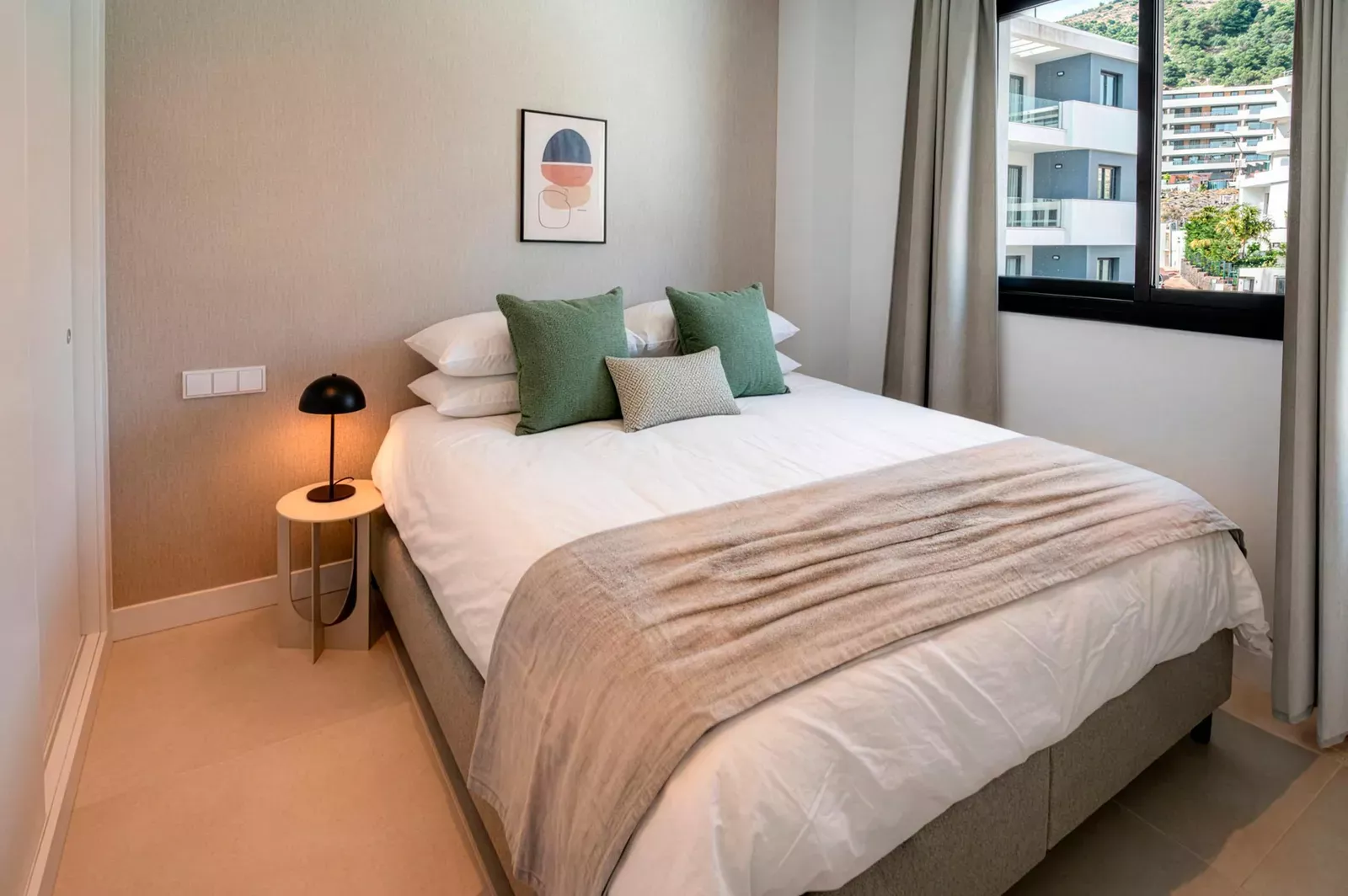 Bedroom with a double bed, green cushions and a window in HW3