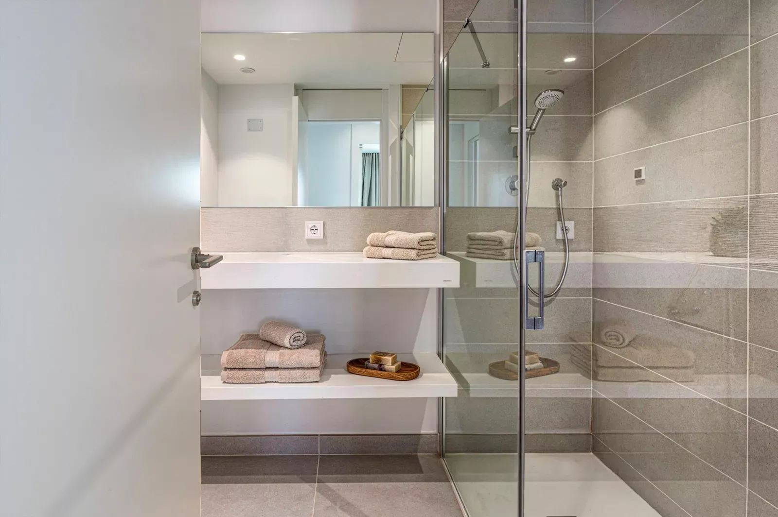 Bathroom with a glass shower and double vanity in the HW3 apartment