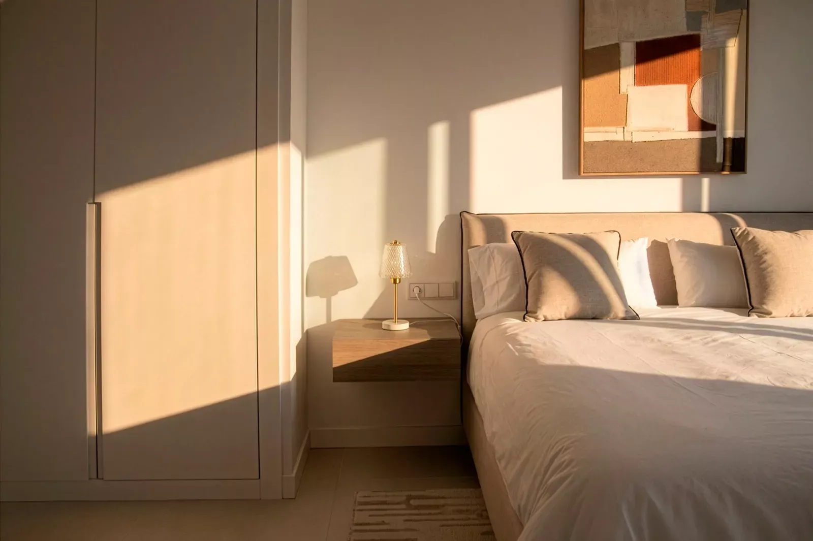 Sunlight on the bed in a bedroom of the HW3 apartment