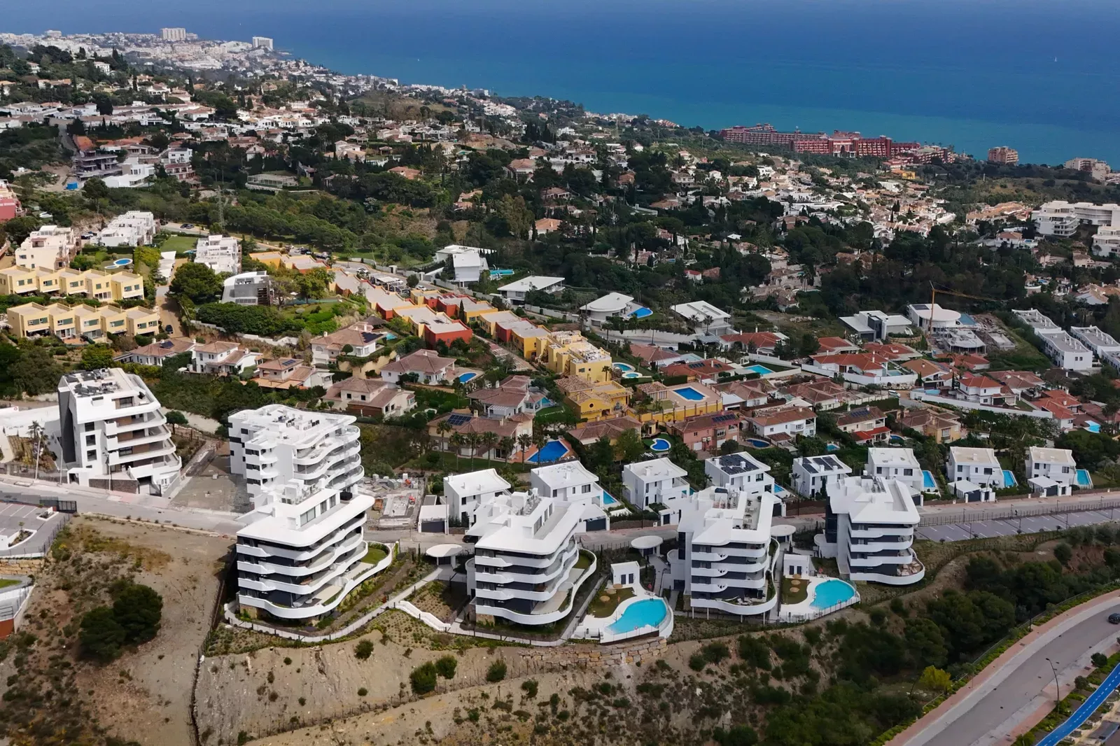 Aerial view of the Higuerón West development with the sea in the background