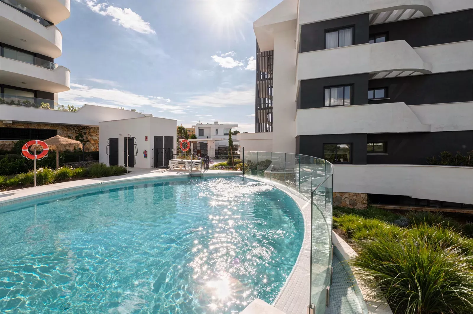 Swimming pool with an apartment building behind at HW3