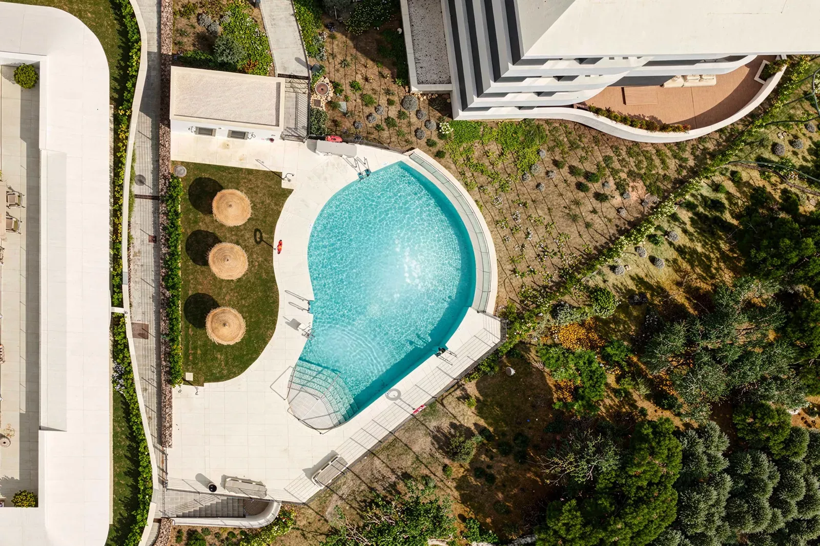 Round pool between gardens seen from above at the HW3 development