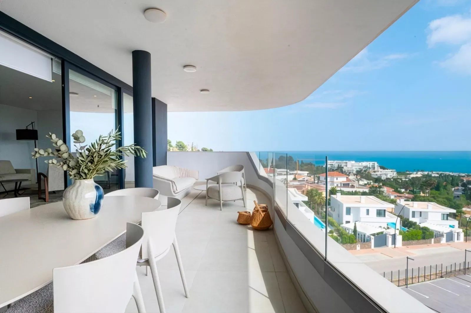 Long terrace with a glass balustrade and sea views at HW3