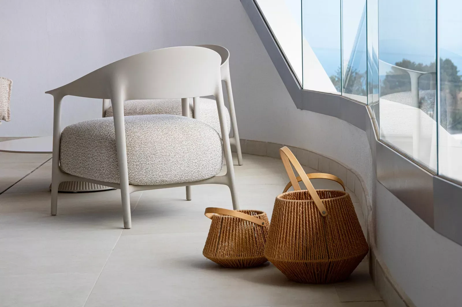 Armchair and wicker basket beside a large window in HW3