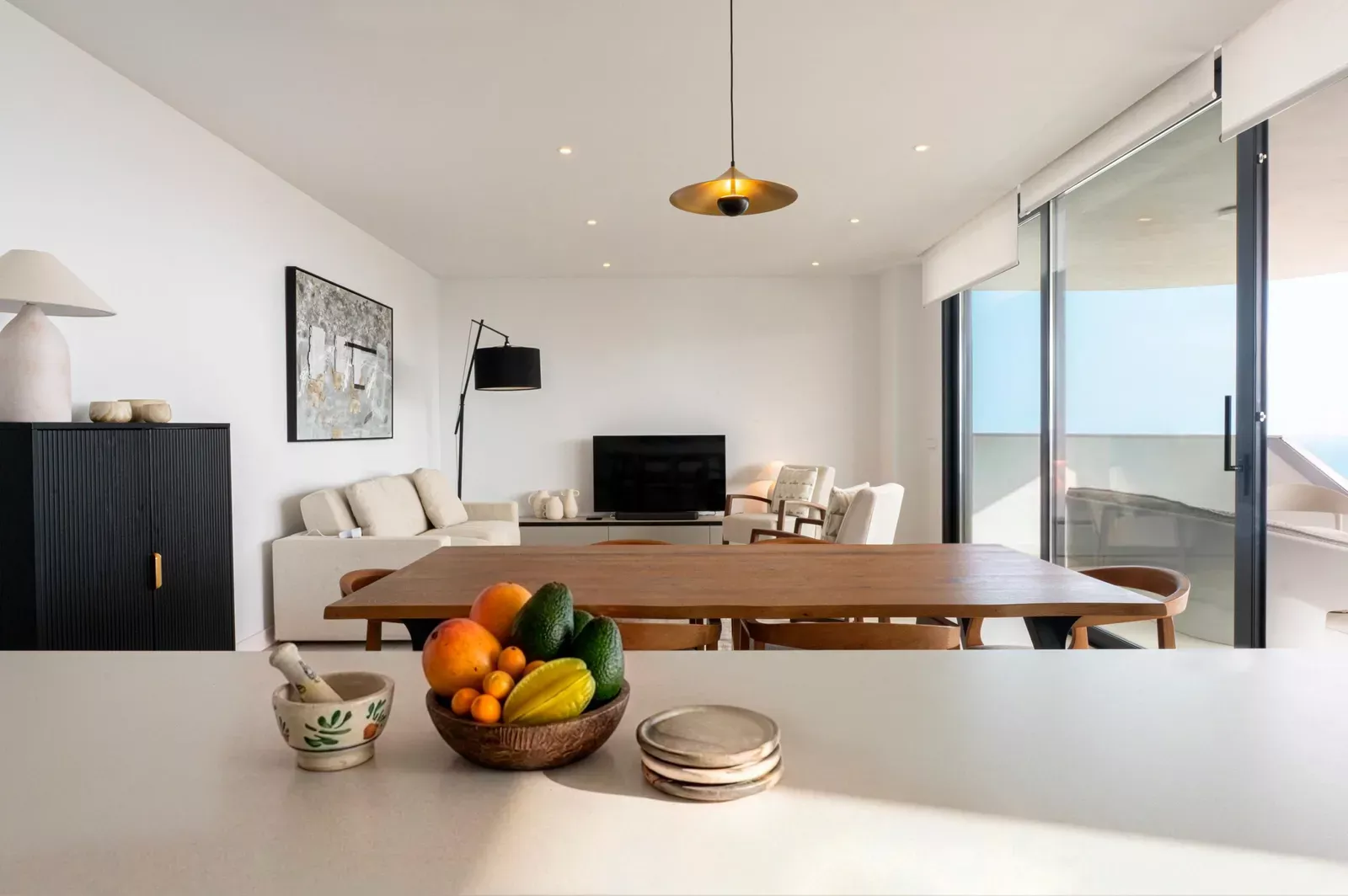 Living and dining room with a fruit bowl on the table in HW3