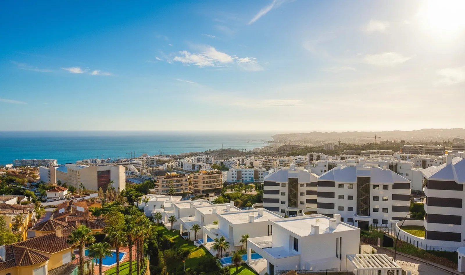 White apartment block with terraces and the sea behind in the HW5 penthouse area