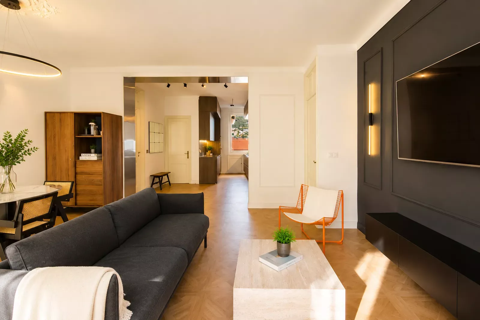 Living area seen from the hallway with a dark sofa in the Nice apartment