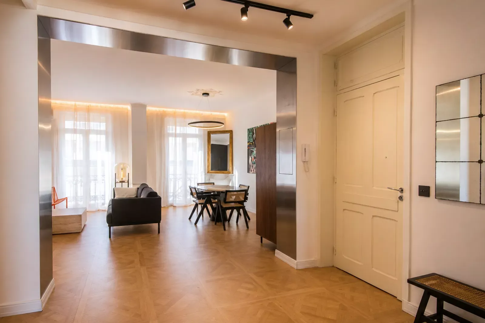 Open living and dining space with wooden floor and high ceilings in Nice