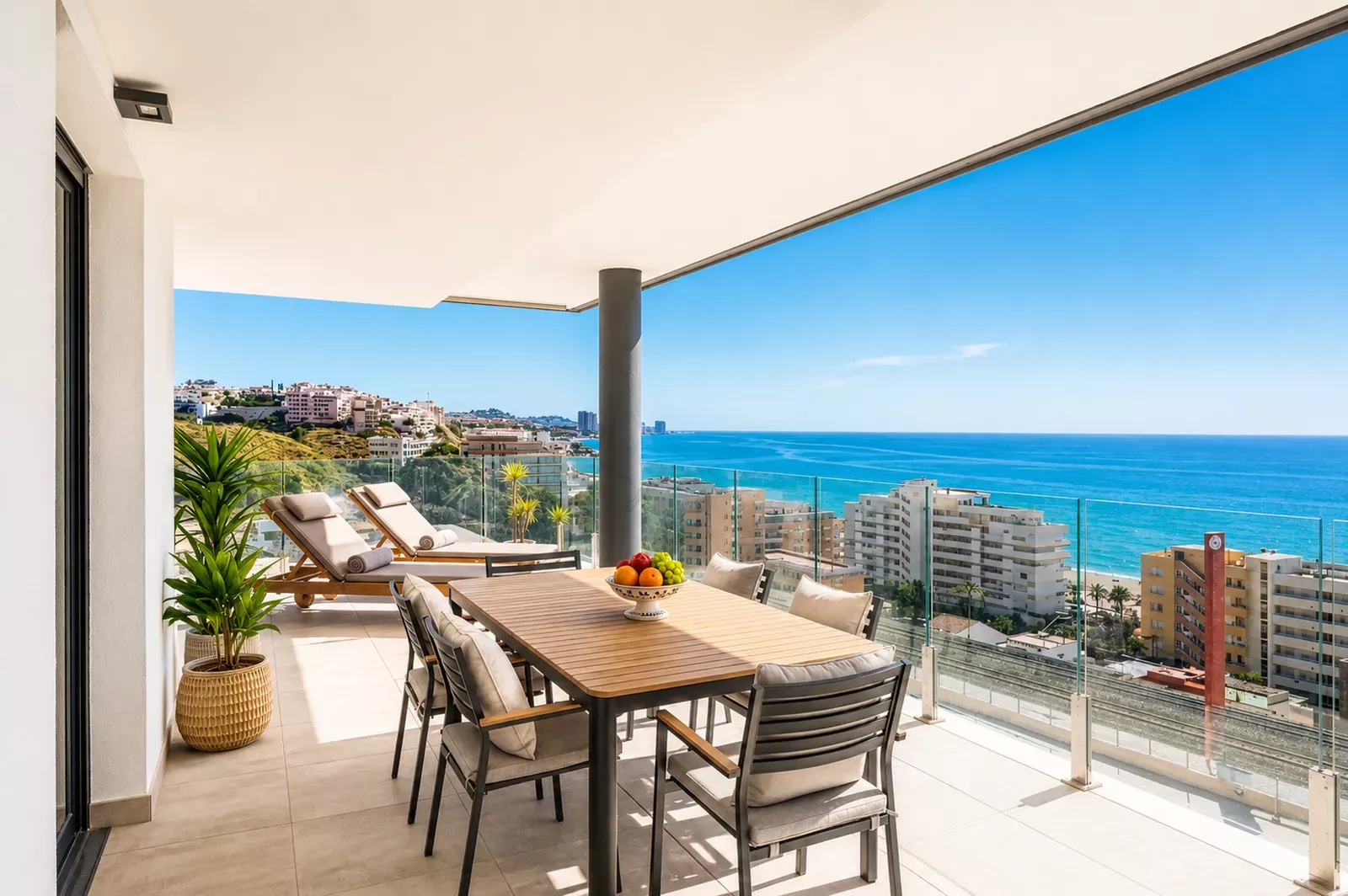 Terrace with a dining table overlooking the sea in the SR2F penthouse