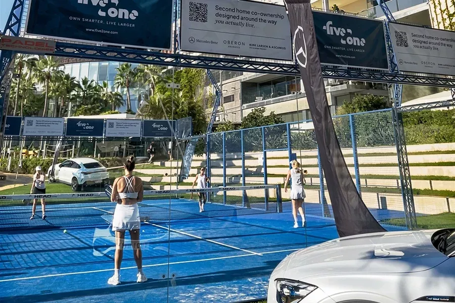 Woman playing padel on a blue court at the five2one Padel Open