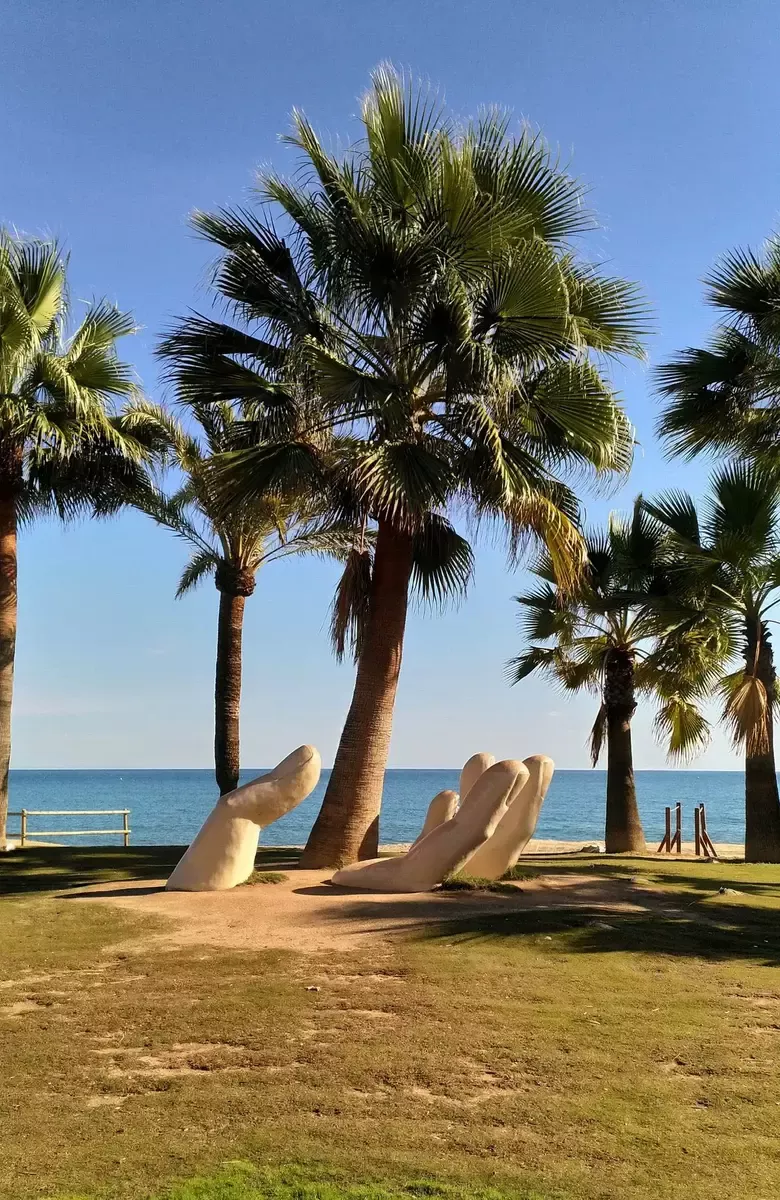 Palm trees on the Fuengirola promenade with the sea in the background