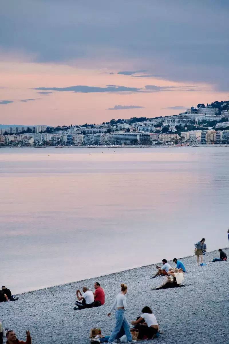 Nice seafront beach at dusk with a pink sky, vertical view